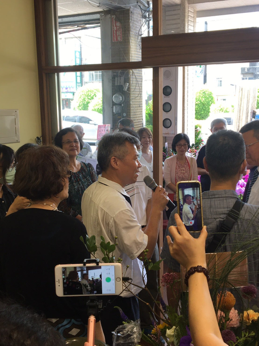 A green cup of a coffee on a wooden table